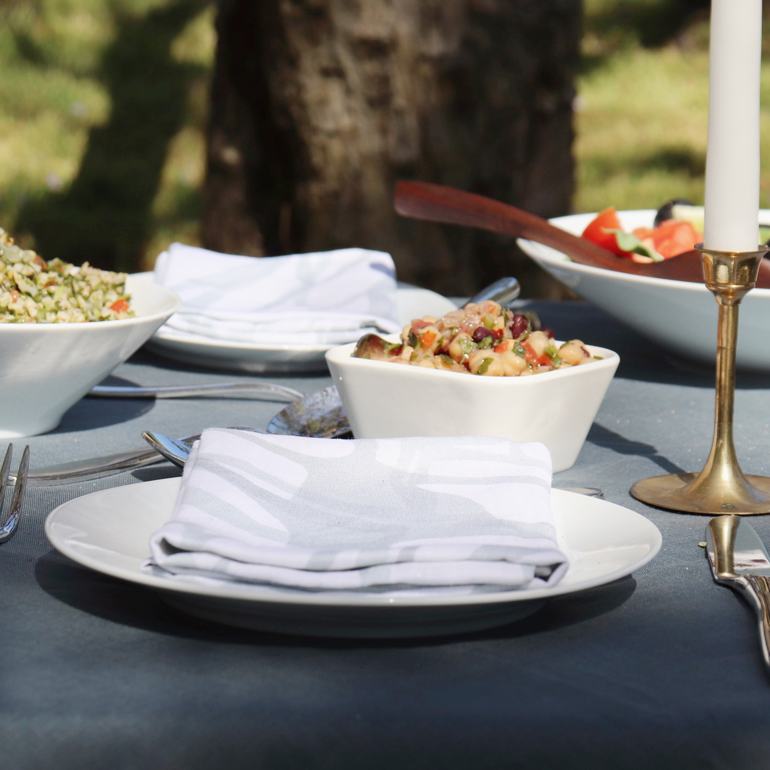 Outdoor dining that's big on style and flavor - shades of green linens for a luxurious picnic