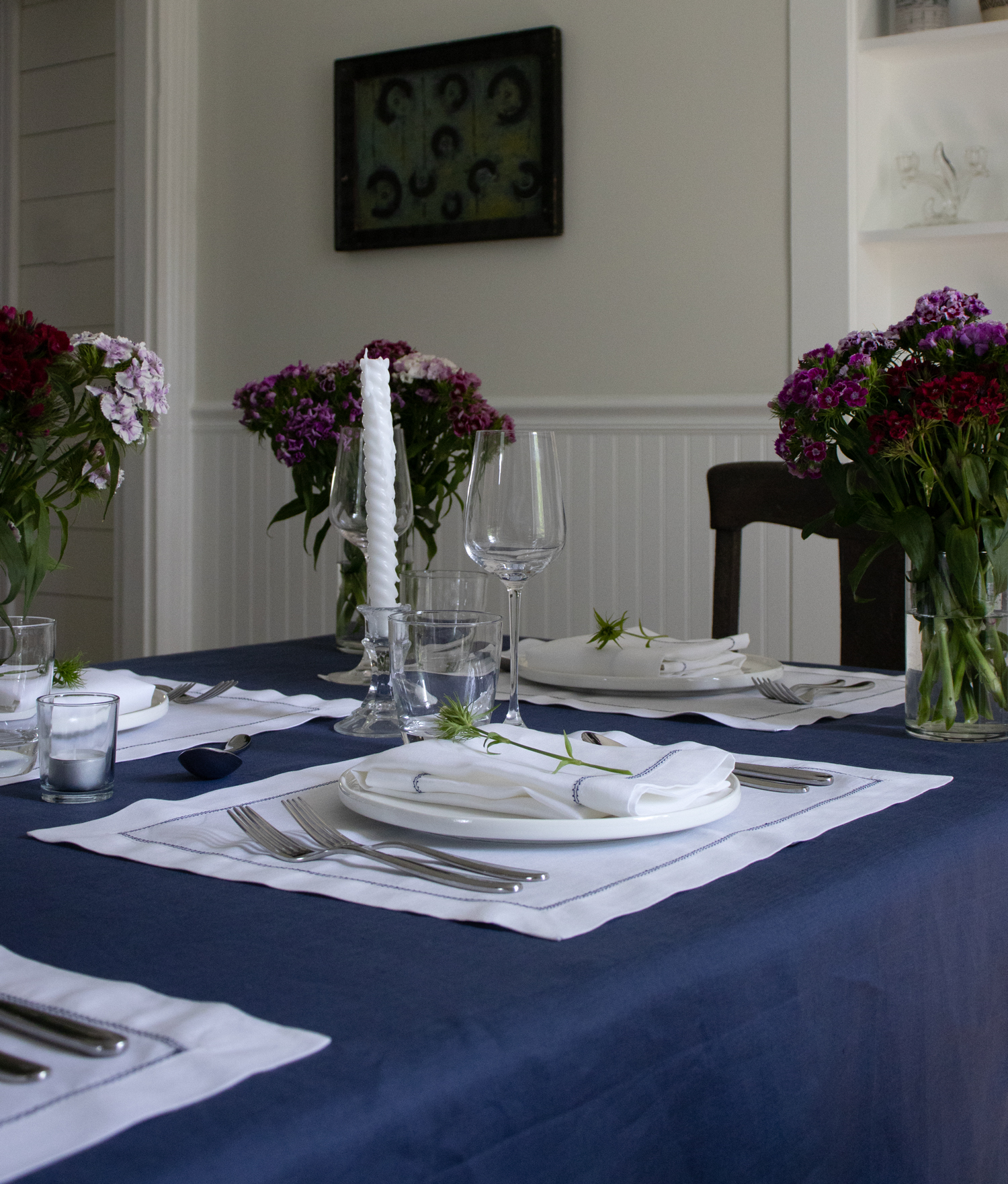 Hemstitched white linen placemats and napkins navy blue trim